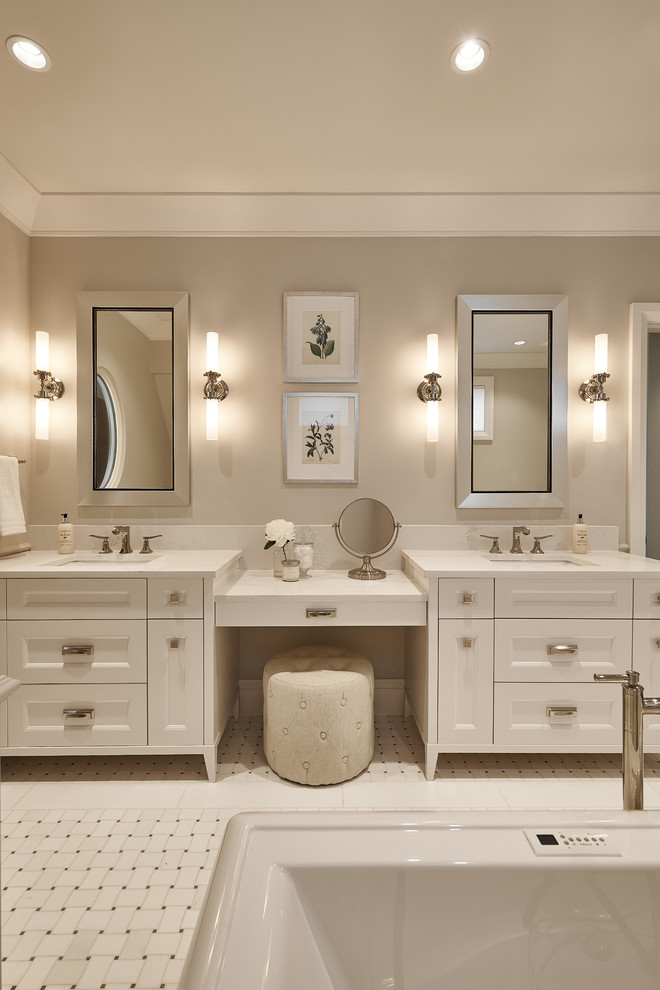 Example of a large transitional master marble floor and white floor freestanding bathtub design in Vancouver with shaker cabinets, white cabinets, a one-piece toilet, beige walls, an undermount sink, quartz countertops and white countertops
