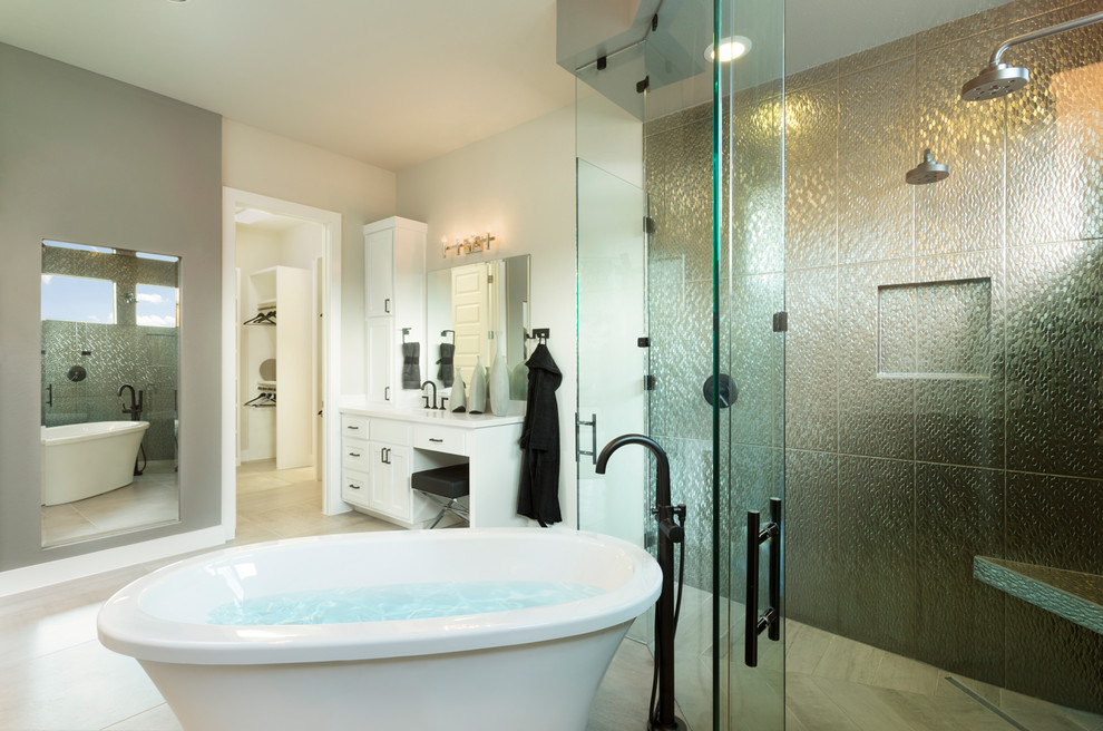 This is an example of a traditional ensuite bathroom in Austin with shaker cabinets, white cabinets, a freestanding bath, a built-in shower, grey walls, a submerged sink, white floors, a hinged door and white worktops.