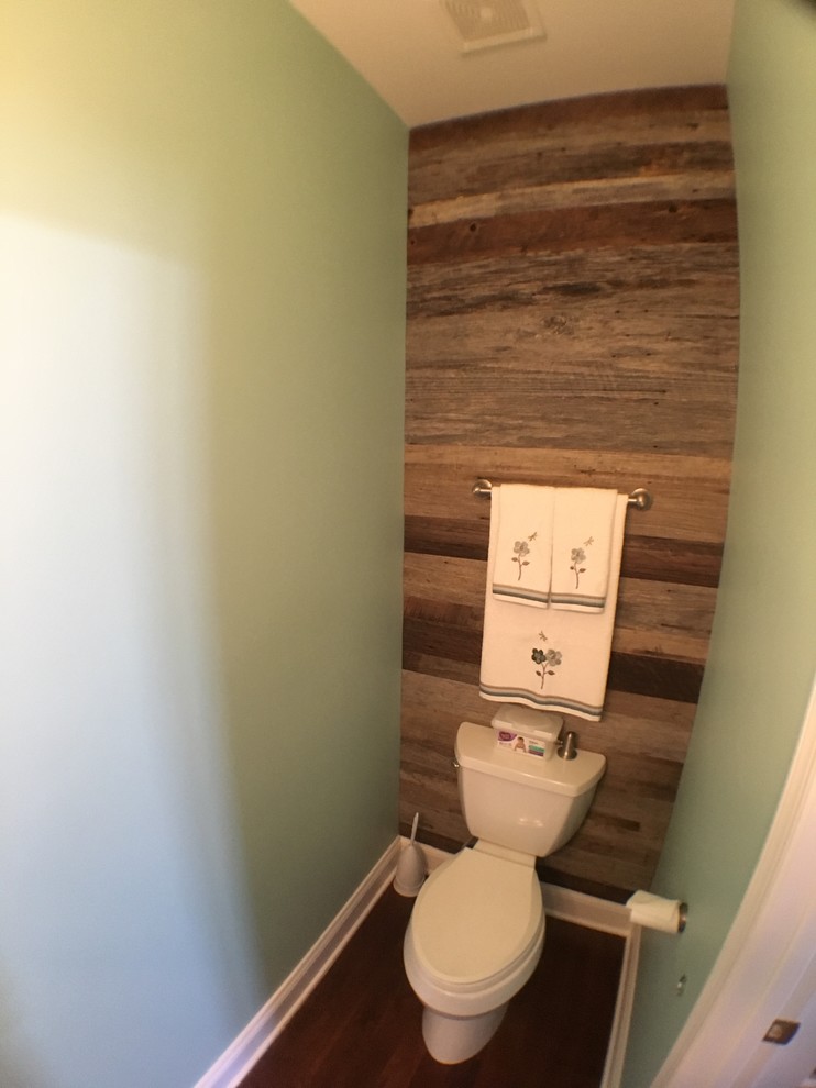 Photo of a small classic bathroom in DC Metro with a two-piece toilet, green walls and dark hardwood flooring.