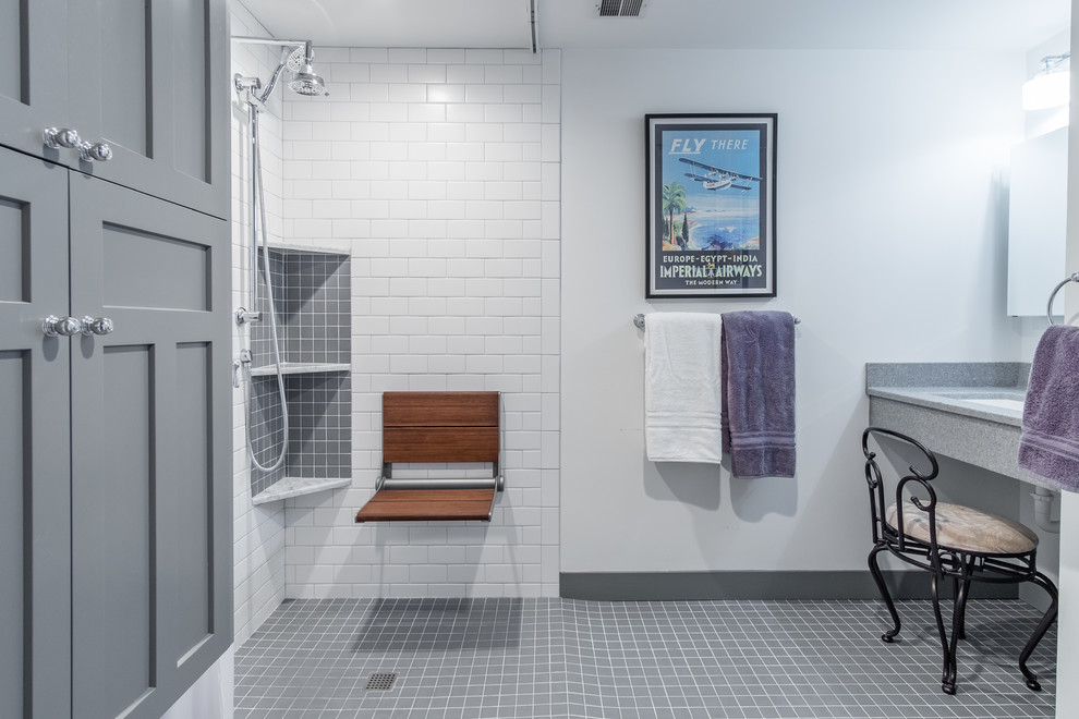 This is an example of a small farmhouse ensuite bathroom in Kansas City with shaker cabinets, grey cabinets, a wall mounted toilet, white tiles, metro tiles, white walls, ceramic flooring, onyx worktops, grey floors, a shower curtain, a built-in shower and an integrated sink.