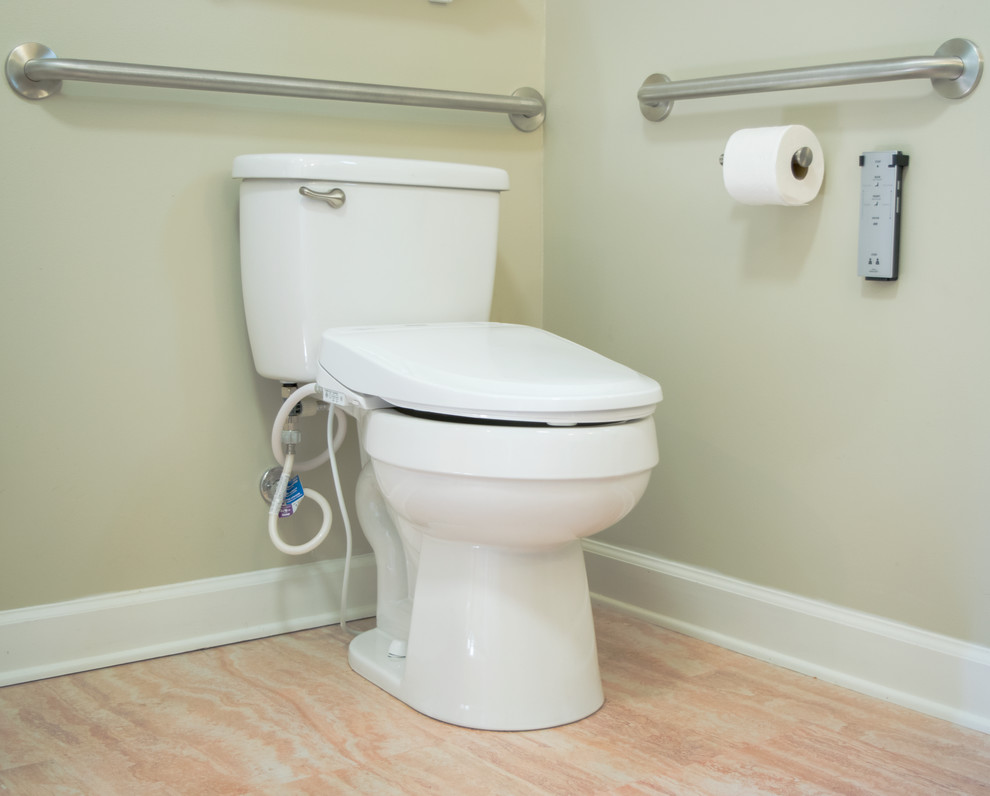 Example of a mid-sized classic cork floor and beige floor powder room design in New Orleans with black cabinets, a two-piece toilet, green walls and granite countertops