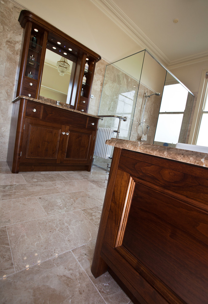 Inspiration for a mid-sized timeless master beige tile and stone tile marble floor bathroom remodel in Kent with an undermount sink, beaded inset cabinets, dark wood cabinets, granite countertops and a wall-mount toilet