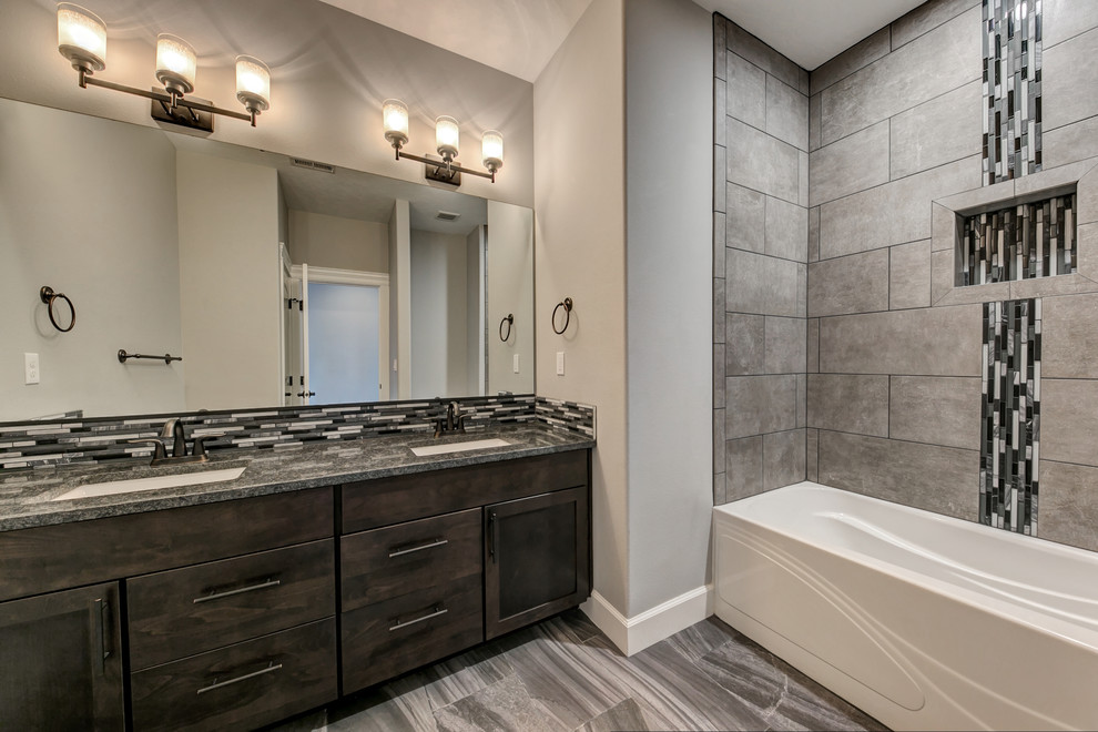 Mid-sized transitional gray tile and glass tile porcelain tile and gray floor bathroom photo in Seattle with shaker cabinets, dark wood cabinets, gray walls, an undermount sink and granite countertops