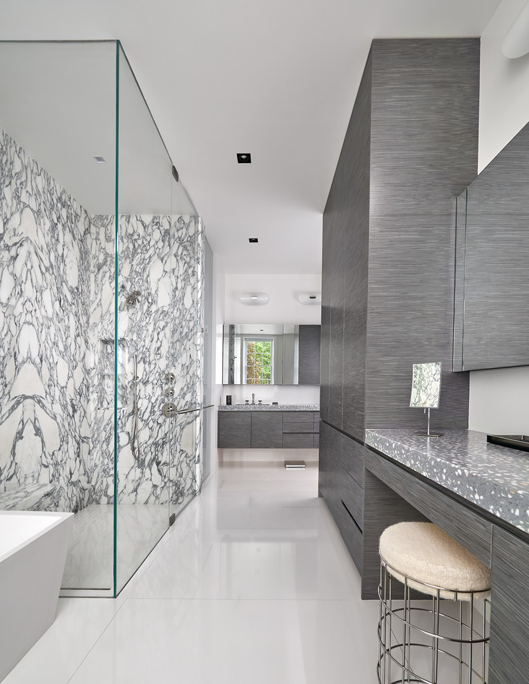 Trendy black and white tile and stone slab white floor bathroom photo in DC Metro with concrete countertops, flat-panel cabinets, gray cabinets, white walls, a hinged shower door and gray countertops