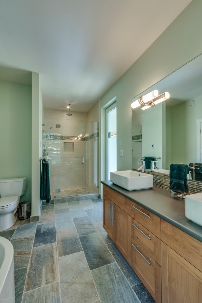 Mid-sized transitional master white tile and ceramic tile slate floor bathroom photo in Vancouver with a vessel sink, shaker cabinets, medium tone wood cabinets, laminate countertops, a two-piece toilet and green walls