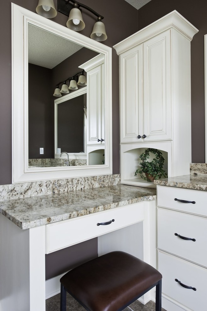 This is an example of a large traditional ensuite bathroom in Grand Rapids with flat-panel cabinets, white cabinets, a freestanding bath, brown walls, slate flooring, a submerged sink and granite worktops.