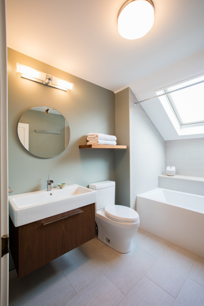 Réalisation d'une salle de bain design en bois foncé avec un placard à porte plane, WC séparés, un carrelage gris, un mur gris, un lavabo posé et une cabine de douche avec un rideau.