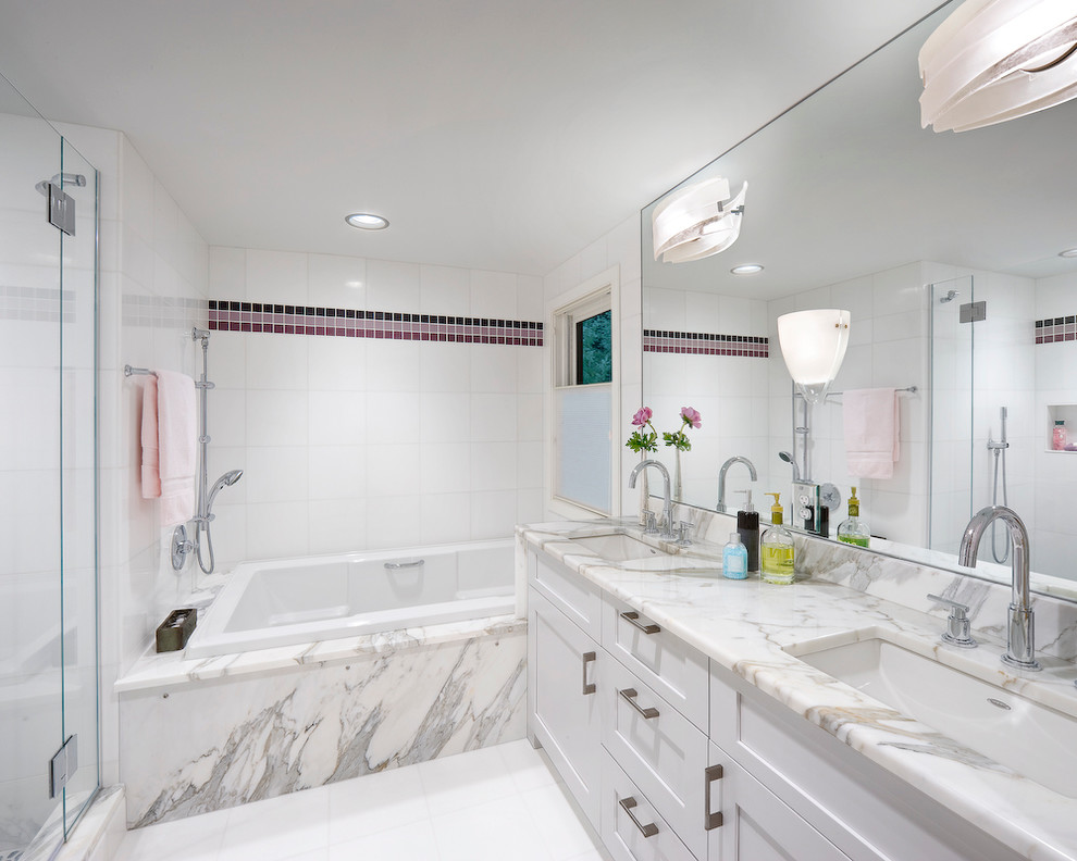 Photo of a classic bathroom in Boston with white cabinets, a built-in bath and white worktops.