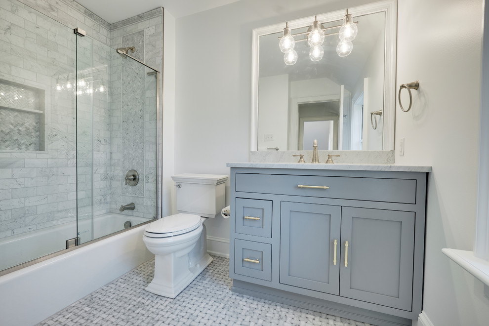 This is an example of a small traditional family bathroom in Philadelphia with flat-panel cabinets, grey cabinets, a built-in bath, a corner shower, a one-piece toilet, multi-coloured tiles, marble tiles, white walls, marble flooring, marble worktops, multi-coloured floors and a sliding door.