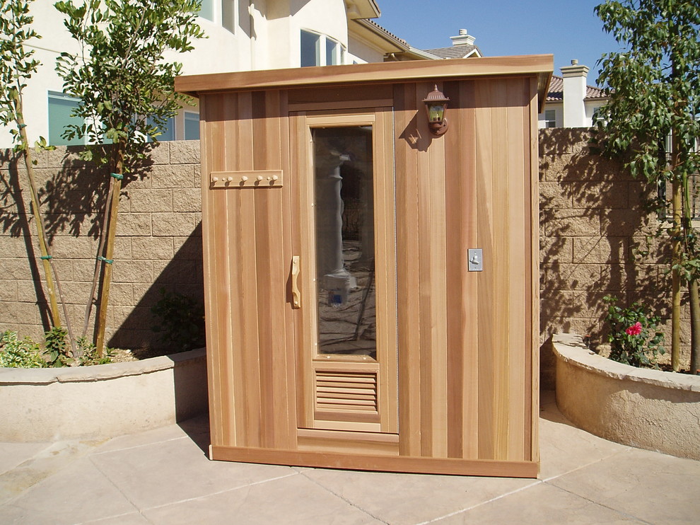 This is an example of a medium sized contemporary sauna bathroom in Los Angeles with brown walls, medium hardwood flooring and brown floors.
