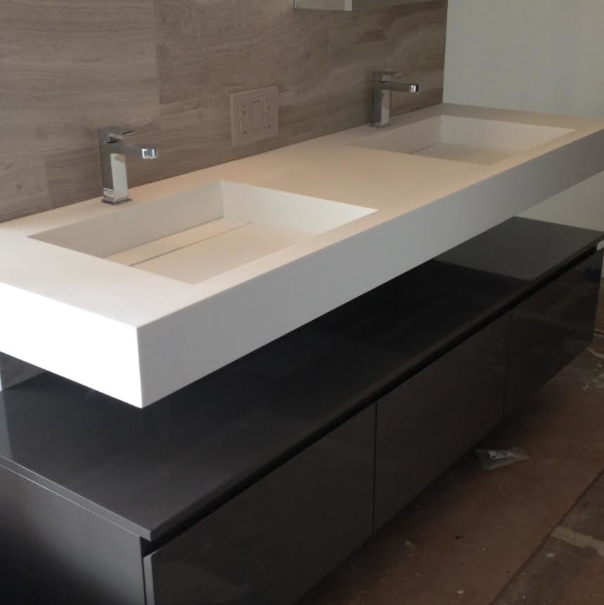 Example of a large trendy master brown floor bathroom design in Los Angeles with a wall-mount sink, flat-panel cabinets, gray cabinets, beige walls, solid surface countertops and white countertops
