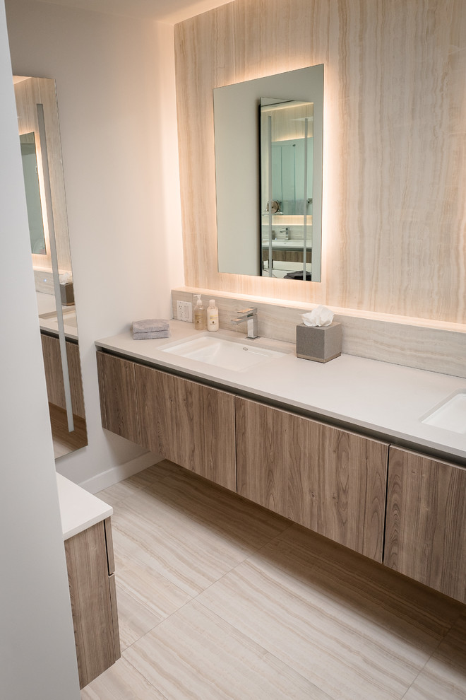 Example of a mid-sized minimalist master brown tile and marble tile marble floor and white floor bathroom design in Los Angeles with flat-panel cabinets, dark wood cabinets, an undermount tub, a wall-mount toilet, brown walls, a vessel sink, quartz countertops and white countertops