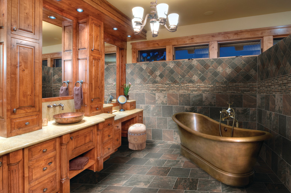 Large mountain style master multicolored tile and porcelain tile porcelain tile and multicolored floor freestanding bathtub photo in Nashville with raised-panel cabinets, medium tone wood cabinets, multicolored walls and a vessel sink