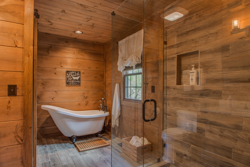 Design ideas for a small rustic family bathroom in Nashville with flat-panel cabinets, white cabinets, a freestanding bath, a two-piece toilet, grey tiles, ceramic tiles, brown walls, ceramic flooring, a built-in sink, granite worktops, grey floors and a shower curtain.