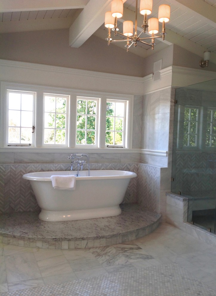 Large traditional ensuite bathroom in Los Angeles with recessed-panel cabinets, white cabinets, a freestanding bath, an alcove shower, a one-piece toilet, white tiles, marble tiles, grey walls, marble flooring, a submerged sink, marble worktops, grey floors, a hinged door and white worktops.