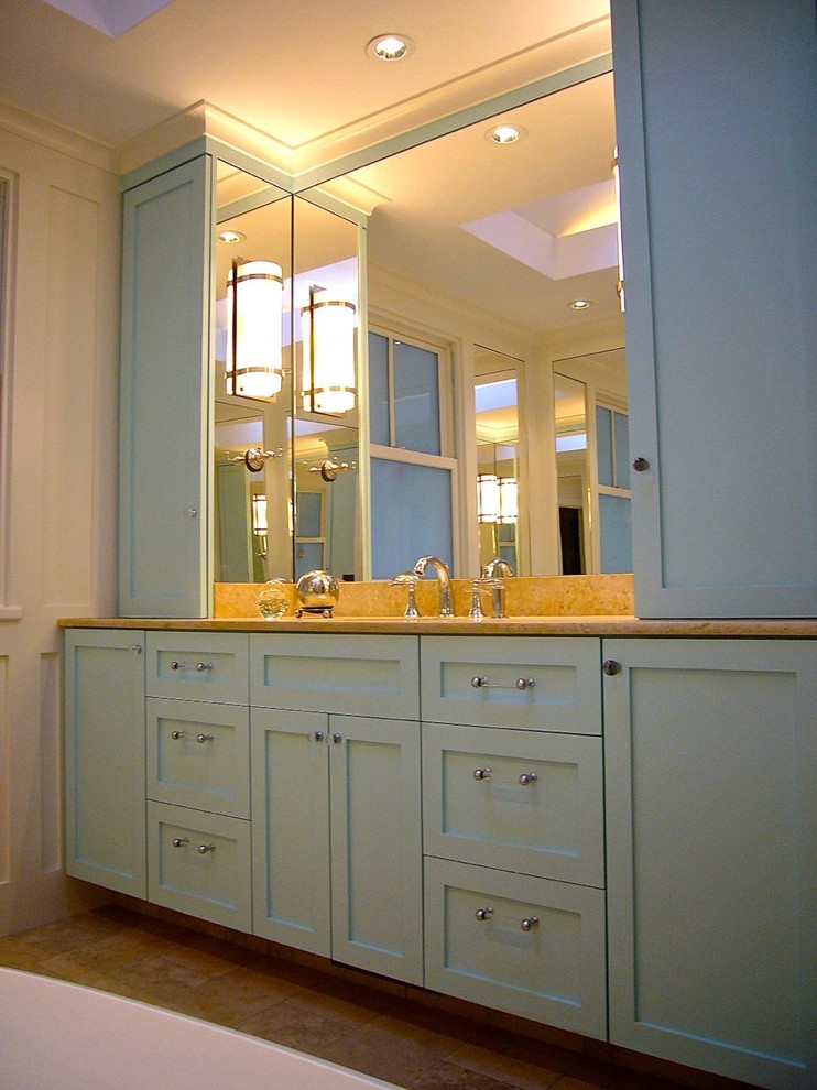 Example of a mid-sized eclectic master limestone floor freestanding bathtub design in San Francisco with shaker cabinets, blue cabinets, a one-piece toilet and limestone countertops