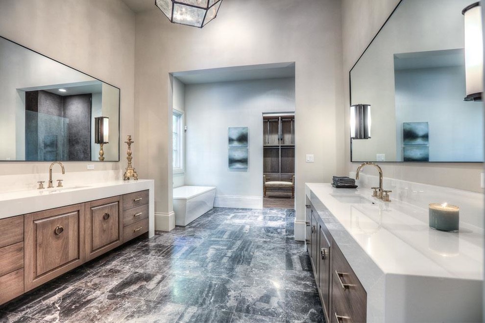 Inspiration for a medium sized classic ensuite bathroom in Houston with recessed-panel cabinets, white cabinets, a freestanding bath, grey tiles, white walls, marble flooring, a submerged sink and solid surface worktops.