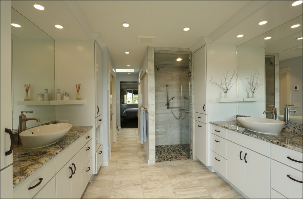This is an example of a medium sized traditional ensuite bathroom in Portland with flat-panel cabinets, white cabinets, a built-in shower, beige tiles, blue walls, ceramic flooring, a vessel sink, granite worktops, beige floors, a hinged door and beige worktops.