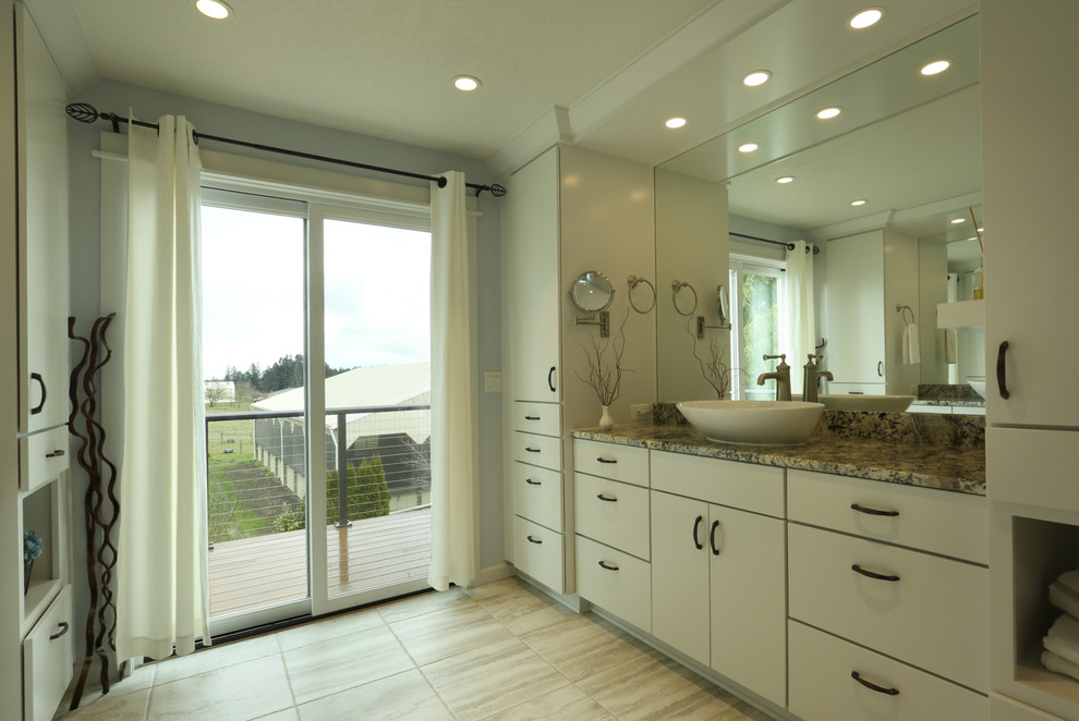 This is an example of a medium sized classic ensuite bathroom in Portland with flat-panel cabinets, white cabinets, a built-in shower, beige tiles, blue walls, ceramic flooring, a vessel sink, granite worktops, beige floors, a hinged door and beige worktops.