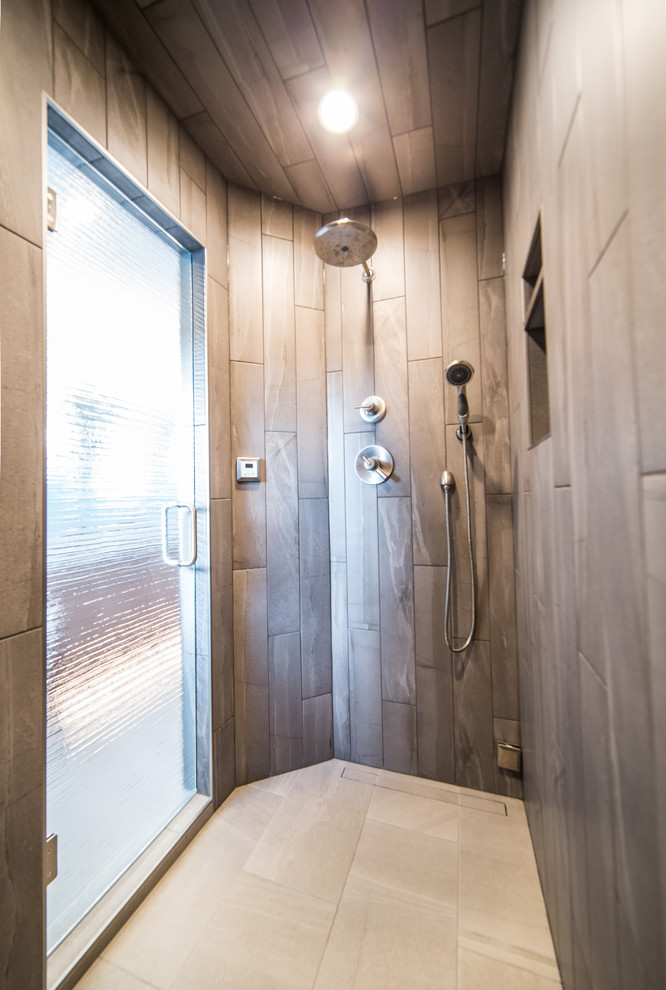 Photo of a large rural ensuite bathroom in Other with flat-panel cabinets, dark wood cabinets, concrete flooring, a japanese bath, a double shower, a one-piece toilet, blue walls, a submerged sink, granite worktops, beige floors and a hinged door.