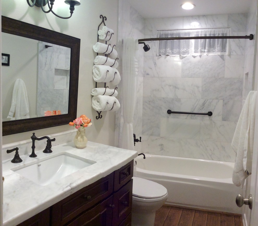 Inspiration for a mid-sized master white tile and stone slab medium tone wood floor bathroom remodel in Los Angeles with a drop-in sink, shaker cabinets, dark wood cabinets, marble countertops, a two-piece toilet and white walls