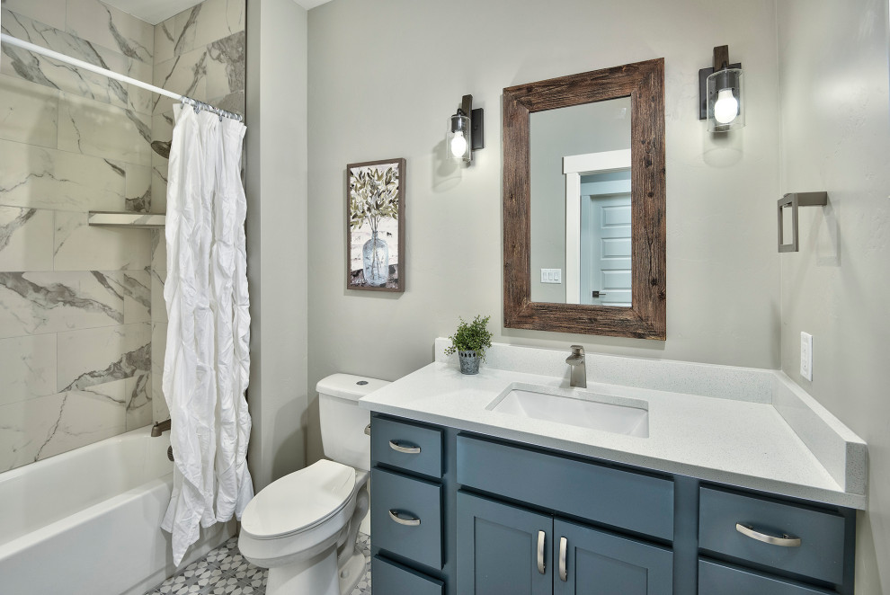 Mid-sized arts and crafts kids' ceramic tile, multicolored floor and single-sink bathroom photo in Other with recessed-panel cabinets, blue cabinets, a two-piece toilet, gray walls, an undermount sink, laminate countertops, gray countertops and a built-in vanity