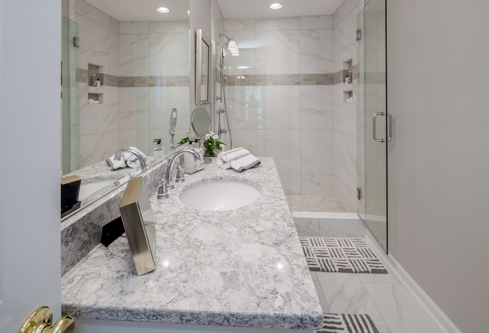 Mid-sized transitional master white tile and porcelain tile porcelain tile doorless shower photo in Atlanta with shaker cabinets, white cabinets, a two-piece toilet, gray walls, an undermount sink and quartz countertops