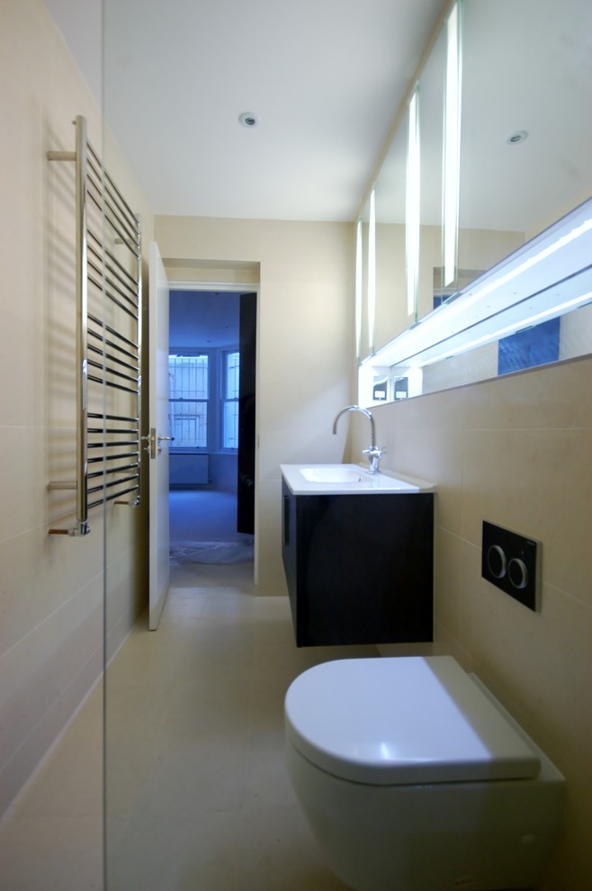Photo of a small contemporary shower room bathroom in London with a built-in sink, flat-panel cabinets, medium wood cabinets, a walk-in shower, a wall mounted toilet, beige tiles, porcelain tiles, beige walls and porcelain flooring.