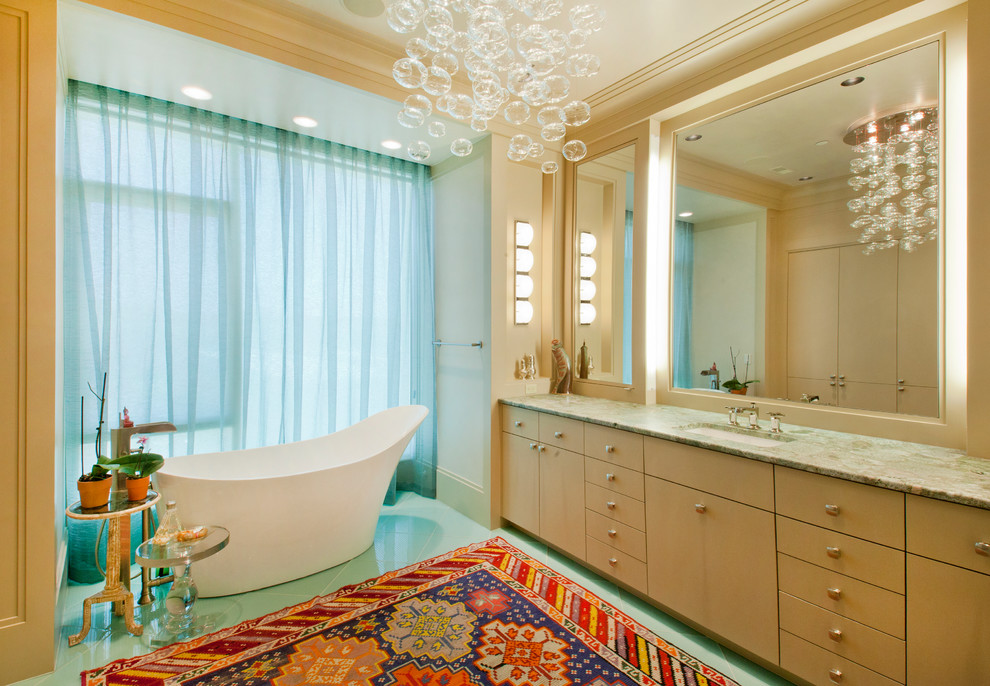 Example of a trendy freestanding bathtub design in Omaha with granite countertops
