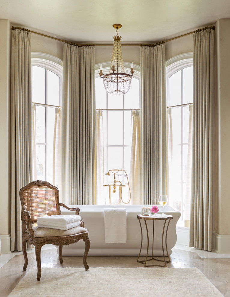 Ispirazione per una grande stanza da bagno padronale classica con vasca freestanding, pareti bianche e pavimento beige