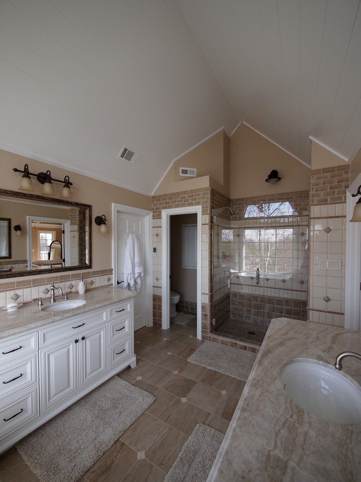Example of a large transitional master beige tile, brown tile, white tile and cement tile porcelain tile and brown floor bathroom design in San Francisco with recessed-panel cabinets, white cabinets, a two-piece toilet, beige walls, an undermount sink, granite countertops and a hinged shower door