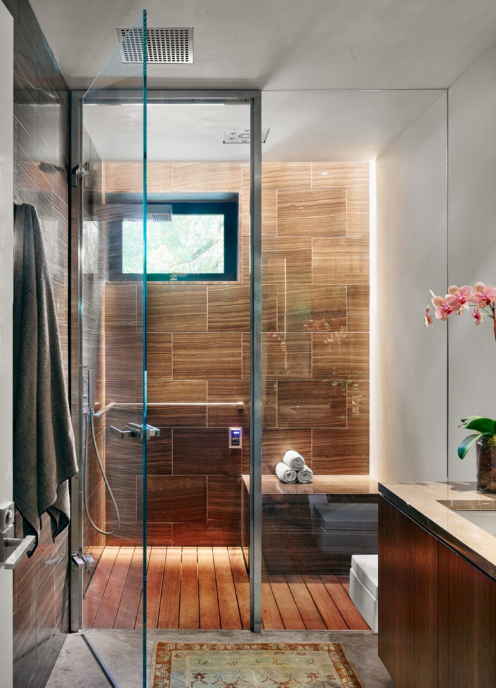 Example of a mid-sized trendy master single-sink, medium tone wood floor and brown floor bathroom design in Austin with flat-panel cabinets, brown cabinets, a one-piece toilet, beige walls, a drop-in sink, a hinged shower door, beige countertops and a built-in vanity