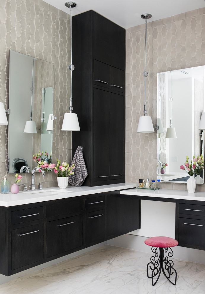 This is an example of a large contemporary ensuite bathroom in San Francisco with flat-panel cabinets, dark wood cabinets, a freestanding bath, a one-piece toilet, white tiles, marble tiles, grey walls, marble flooring, a submerged sink, marble worktops, white floors, a hinged door and white worktops.