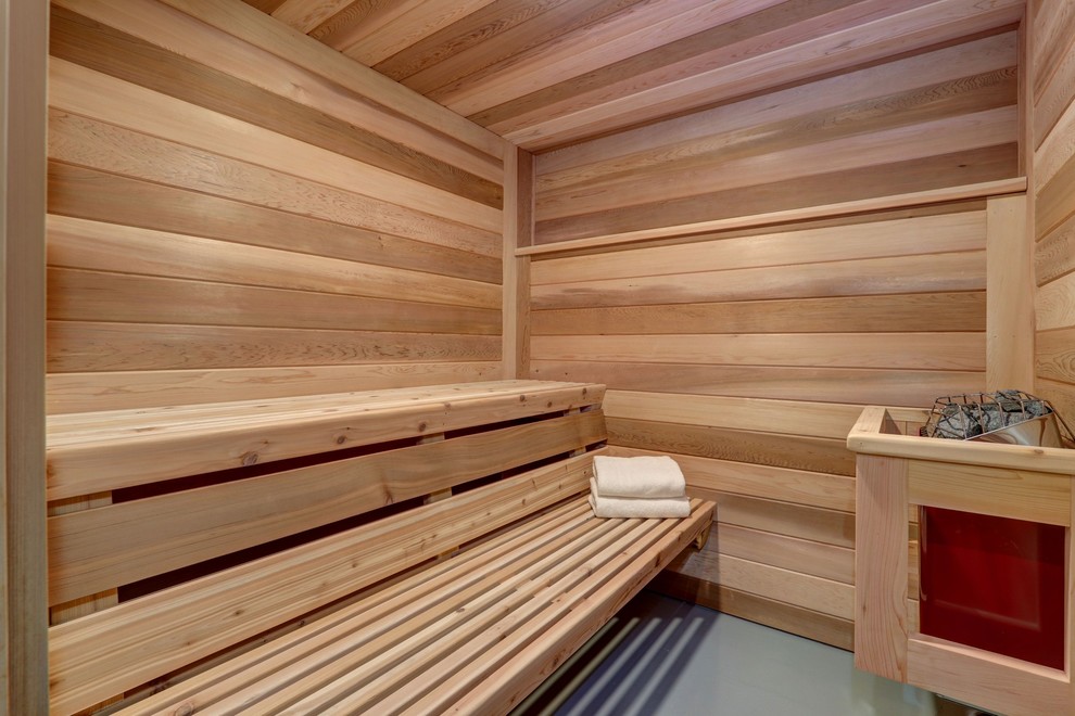 Cette photo montre un sauna scandinave avec un sol gris.