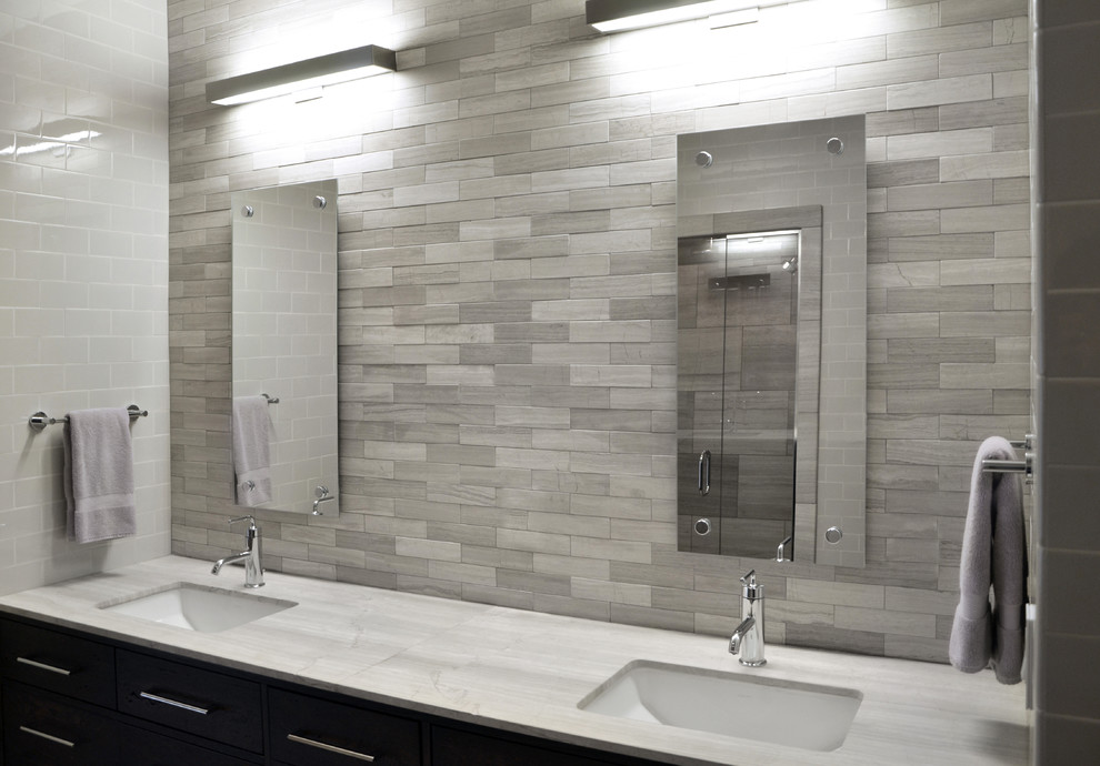 Bathroom - large modern gray tile and stone tile porcelain tile bathroom idea in Chicago with an undermount sink, flat-panel cabinets, dark wood cabinets, marble countertops, a one-piece toilet and white walls