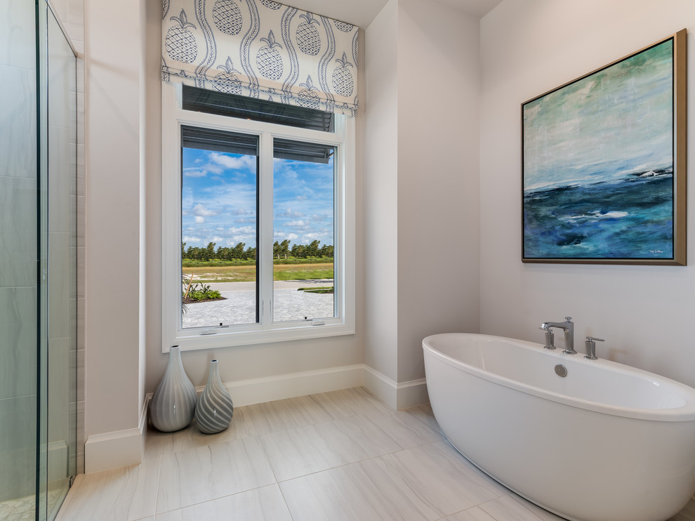 Example of a large beach style master beige floor bathroom design in Miami with gray walls and a hinged shower door