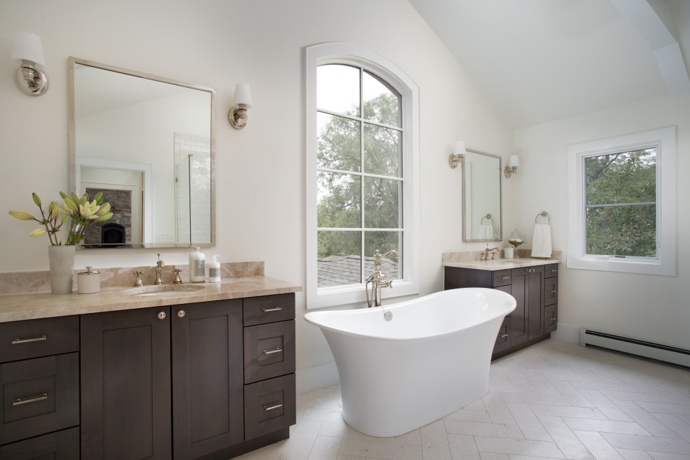 Large classic ensuite bathroom in Denver with shaker cabinets, medium wood cabinets, a freestanding bath, beige walls, a submerged sink, grey floors, brown worktops, double sinks and a built in vanity unit.