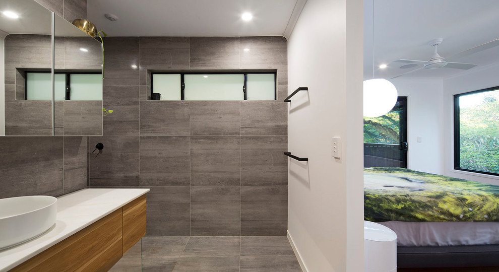 Design ideas for a medium sized contemporary bathroom in Brisbane with flat-panel cabinets, light wood cabinets, a freestanding bath, a walk-in shower, grey tiles, porcelain tiles, grey walls, porcelain flooring, a vessel sink, marble worktops, grey floors, an open shower and white worktops.