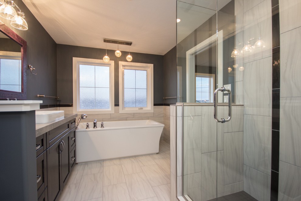 Example of a large transitional master white tile and porcelain tile porcelain tile bathroom design in Calgary with a drop-in sink, shaker cabinets, dark wood cabinets, laminate countertops, a one-piece toilet and gray walls