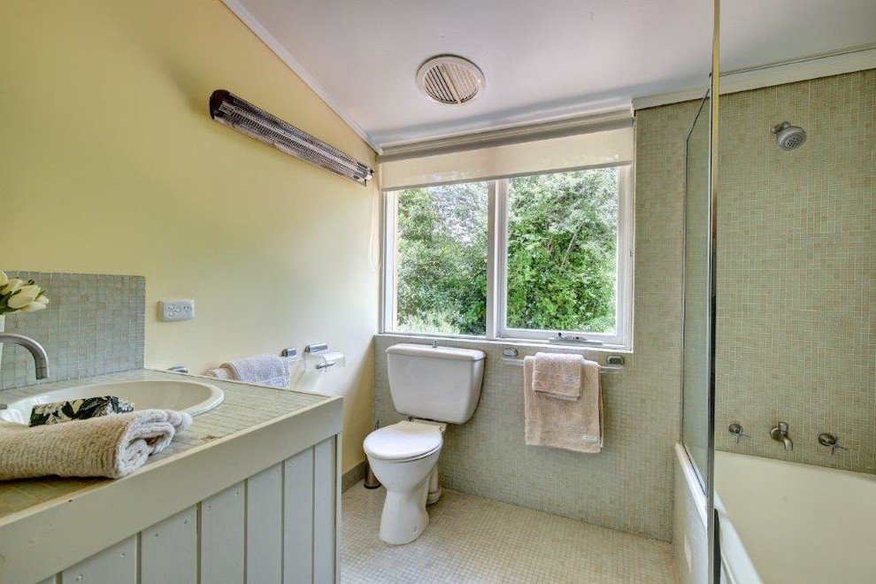 Esempio di una stanza da bagno country di medie dimensioni con pareti gialle e pavimento beige