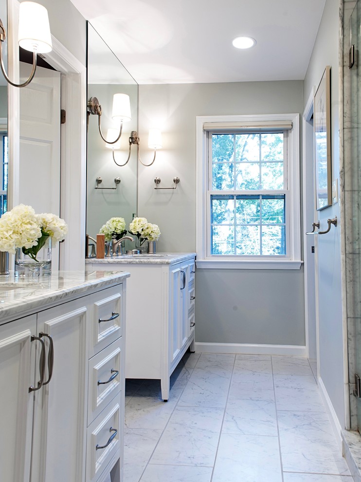 Inspiration for a mid-sized timeless master porcelain tile double shower remodel in DC Metro with furniture-like cabinets, white cabinets, a one-piece toilet, gray walls, an undermount sink, marble countertops, a hinged shower door and white countertops