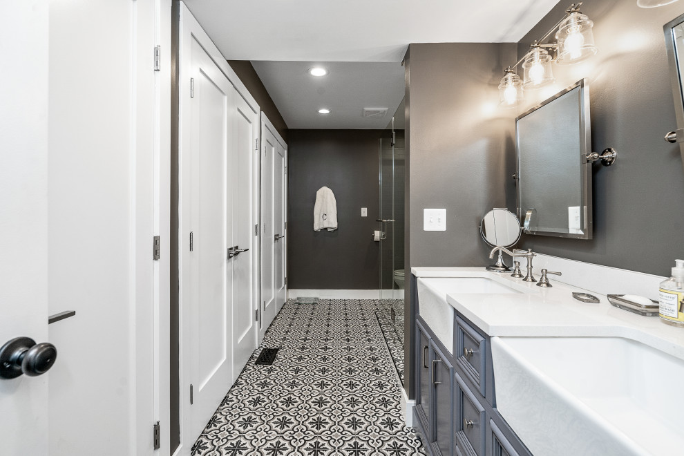 Photo of a large traditional ensuite bathroom in DC Metro with recessed-panel cabinets, blue cabinets, grey walls, mosaic tile flooring, a submerged sink, multi-coloured floors, white worktops, double sinks and a built in vanity unit.