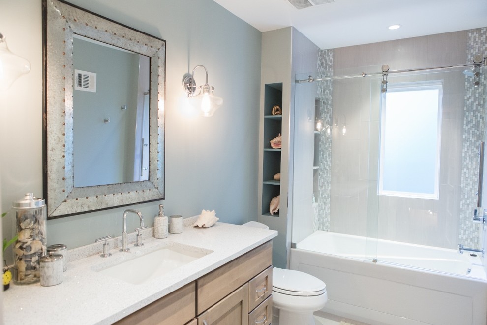 Inspiration for a mid-sized coastal gray tile and glass tile porcelain tile bathroom remodel in DC Metro with an undermount sink, shaker cabinets, quartz countertops, a two-piece toilet, blue walls and light wood cabinets