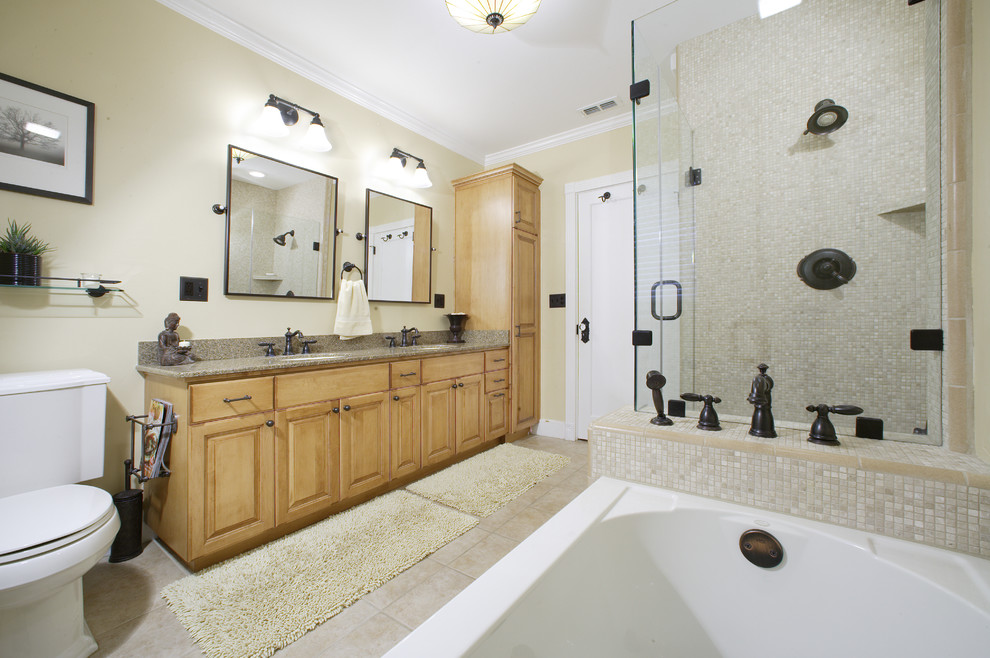 Example of a mid-sized minimalist master beige tile and glass tile ceramic tile bathroom design in Sacramento with a drop-in sink, furniture-like cabinets, medium tone wood cabinets, granite countertops, a two-piece toilet and yellow walls