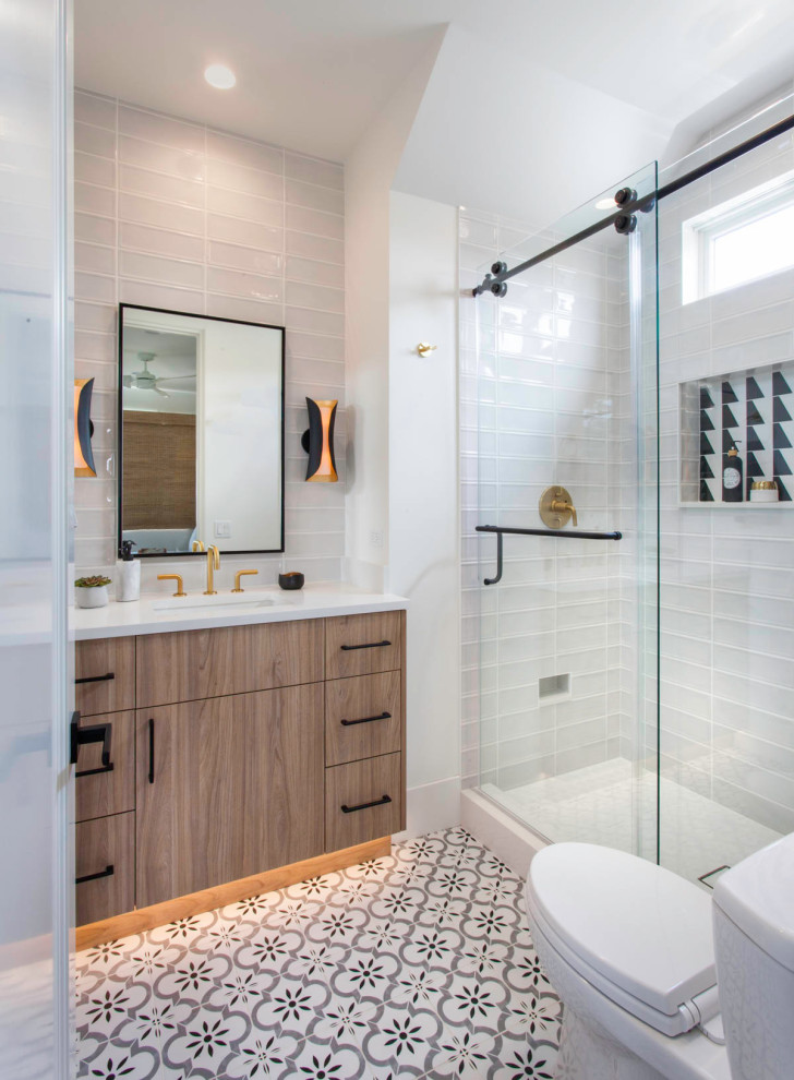 Small beach style gray tile and ceramic tile porcelain tile, black floor and single-sink bathroom photo in San Diego with flat-panel cabinets, light wood cabinets, a two-piece toilet, white walls, an undermount sink, quartz countertops, white countertops, a niche and a built-in vanity