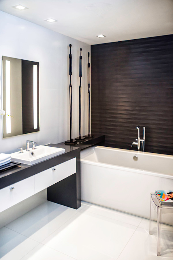 Medium sized modern ensuite bathroom in Miami with a submerged sink, flat-panel cabinets, dark wood cabinets, wooden worktops, a freestanding bath, a wall mounted toilet, white tiles, porcelain tiles, white walls and porcelain flooring.