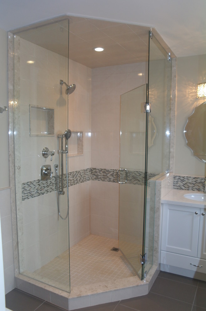 Example of a large transitional master multicolored tile corner shower design in Toronto with shaker cabinets, white cabinets and beige walls