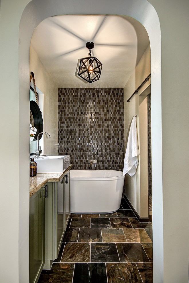 Bathroom - mid-sized transitional master green tile and glass tile slate floor bathroom idea in Phoenix with shaker cabinets, green cabinets, a one-piece toilet, white walls, a vessel sink and quartz countertops