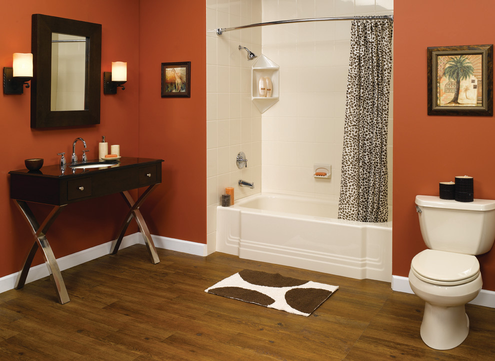 Inspiration for a large contemporary ensuite bathroom in Austin with freestanding cabinets, dark wood cabinets, an alcove bath, a shower/bath combination, a two-piece toilet, white tiles, porcelain tiles, orange walls, medium hardwood flooring, a submerged sink, engineered stone worktops, brown floors and a shower curtain.