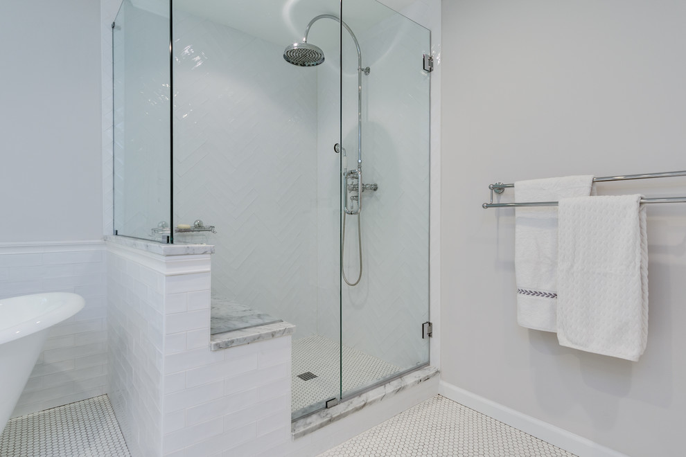 Photo of a large rural ensuite bathroom in Atlanta with shaker cabinets, white cabinets, a claw-foot bath, a corner shower, a two-piece toilet, white tiles, ceramic tiles, grey walls, ceramic flooring, a submerged sink, marble worktops, white floors and a hinged door.